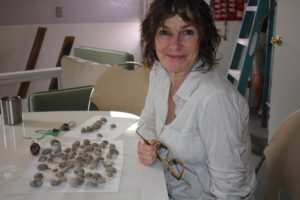 Annalea makes neckles from seashell